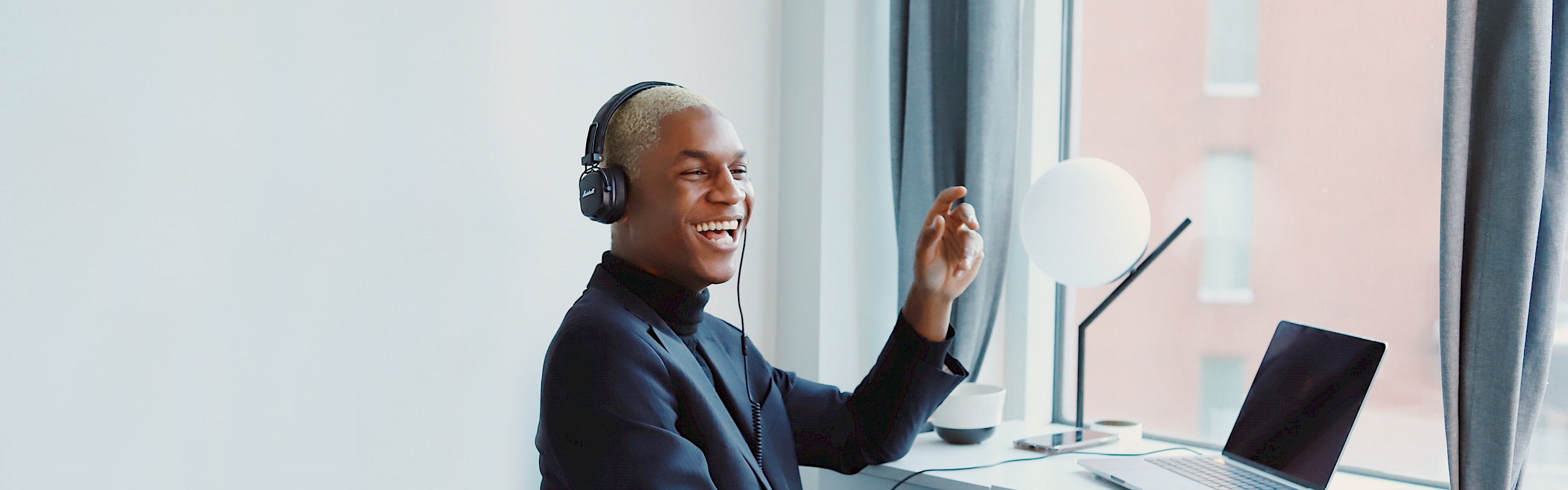 Person sitting at desk with headphones on